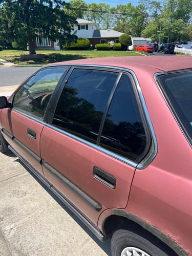 Reviewer's car with dark tinted windows, showing the result of prepping glass with the GT085.