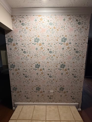 Customer's accent wall fully decorated with the newly installed floral Martie Wallpaper.