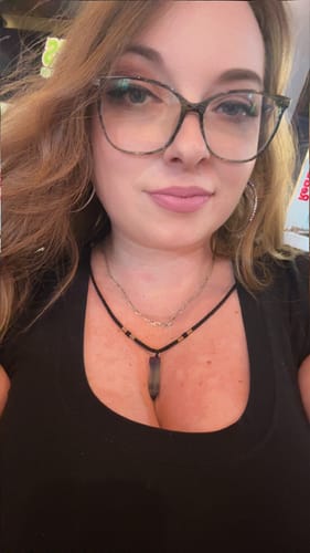 Reviewer wearing a purple crystal point necklace from the VIP Crystal Club.