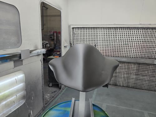 Customer's motorcycle part with a smooth matte gray coat of DTM Primer-Sealer AP-7541 in a paint booth.