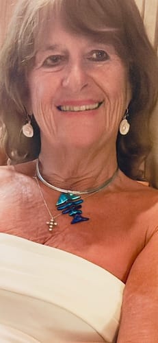 Reviewer's portrait showing skin on her face and chest after using The Micro Infusion System.