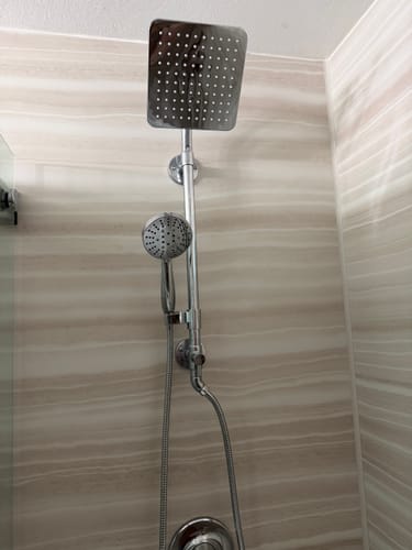 Customer's 8 Inch Square Rain Shower Head and handheld shower installed in their bathroom.