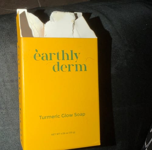 Reviewer's opened yellow box for the Turmeric Fade & Glow Bar.