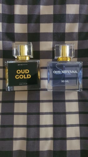 Customer's Oud Gold and Oud Nirvana perfume bottles from The Royal Oud Collection on a plaid surface.