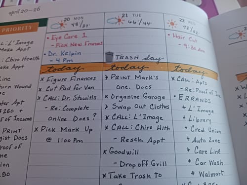 Reviewer's planner showing a small trash day sticker used to mark the event on a weekly schedule.