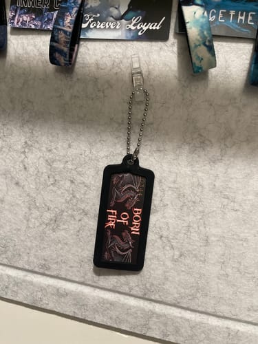 Reviewer's black Cardlox keychain holding a card with 'BORN OF FIRE' text, hanging from a clip.