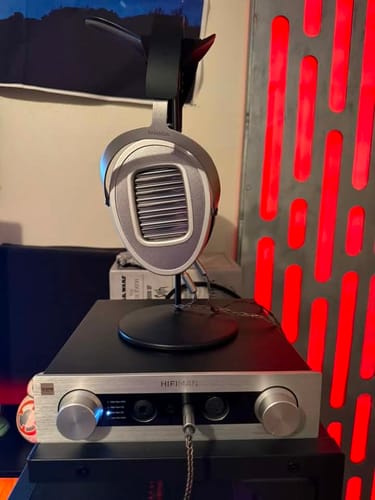 Customer's silver Hifiman Ananda Unveiled headphones on a stand, placed on a matching Hifiman amplifier.