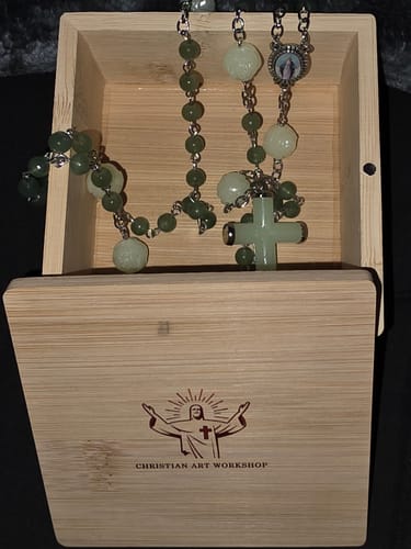 Reviewer's open Christianartworkshop wood gift box with a green jade rosary placed inside.