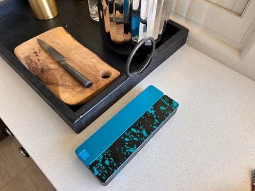 Reviewer's blue and speckled 2-Week Vitamin Case 2.0 resting on a clean white kitchen counter.