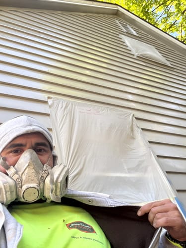 Customer wearing a respirator and the Dunn-Edwards Hi-Visibility Yellow Long Sleeve T-Shirt while working outdoors.