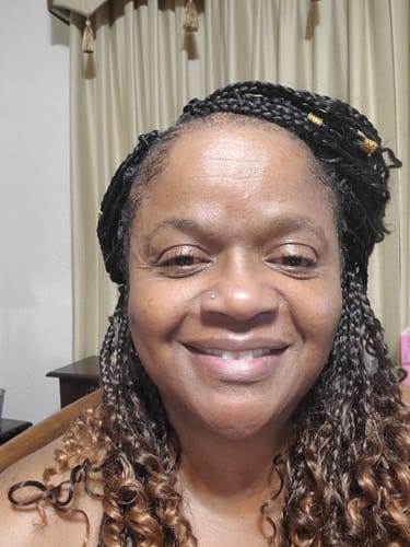 Reviewer smiling, showing their clear skin after using the Turmeric Fade & Glow Bar.