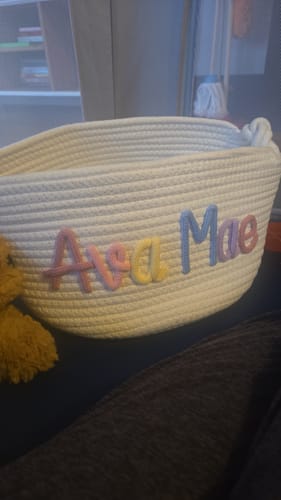 Reviewer's woven basket personalized with the name 'Ava Mae' in pastel colors.