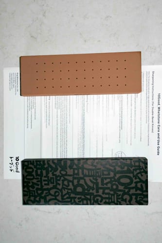 Customer's 10Good Sharpening Whetstone and its box displayed on top of the included instruction guide.
