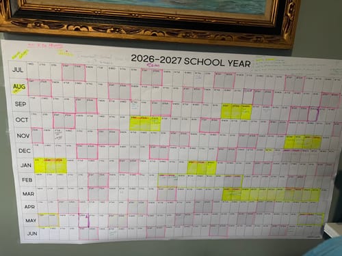 Customer's 2026-27 School Year Calendar on a wall, with dates highlighted and notes written for planning.