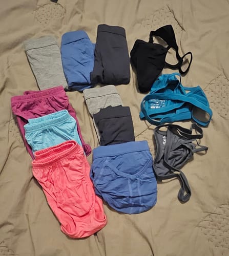 Reviewer's collection of underwear, including various colors of the Modal Boxer Briefs, on a bed.
