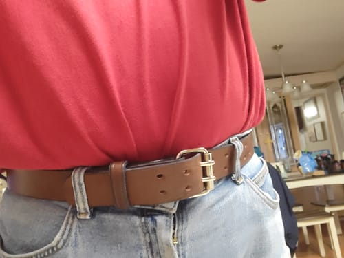 Customer wearing the brown Double Prong Everyday belt with jeans, showing the double-prong buckle.