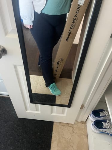 Customer's mirror selfie showing one bright teal Luck Ⅰ - Barefoot Shoe being worn indoors.