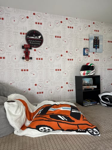 Customer's review photo showing the Lennox Wallpaper on a wall in a car-themed room.