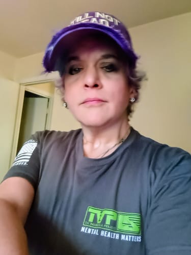 Reviewer wearing a dark grey T.V.P. Elite Membership t-shirt with a green logo reading "Mental Health Matters."