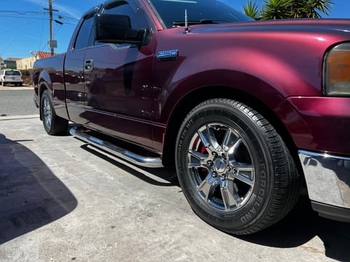 Customer's side view of a shiny maroon truck with a glossy finish after using the Speed Gloss Quick Detailer.