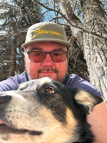 Customer wearing the olive green Big Camp Hat outdoors with their dog.