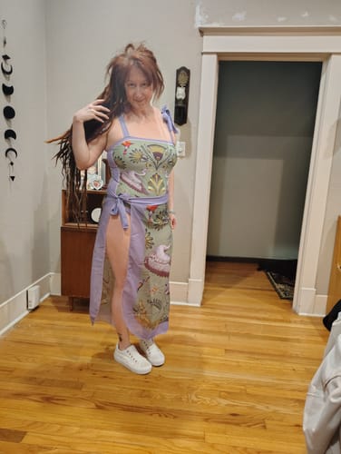 Reviewer shows the 1950s Forest Animals swimsuit with the lavender cover-up skirt worn tied at the hip.