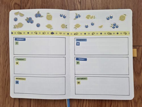Reviewer's weekly planner spread decorated with cute lemon and blueberry stickers from the Ultimate Subscription.