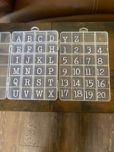 Reviewer's Quilt Bits Block and Row Markers neatly organized in two clear compartment boxes.