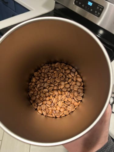 Customer's home-roasted Condor Colombia Decaf beans in a brown container.