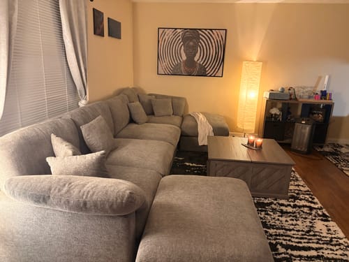 Reviewer's Spirals of Serenity Queen canvas print hanging on a living room wall above a gray sofa.