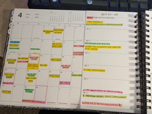 Customer shows their open Nancy Planner with the monthly and weekly views visible, filled out with colorful highlighters.