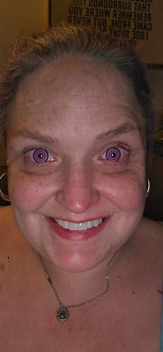 Close-up of a reviewer wearing the purple, spiral Cosplay Midsummer Colored Contact Lenses.