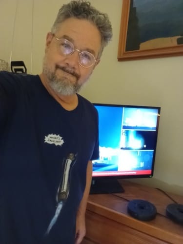 Reviewer smiling in a selfie wearing the dark blue 'Where's Jacklyn?' T-shirt.