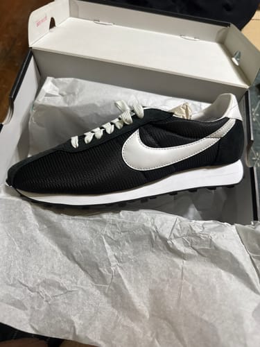 Customer's black Nike LD-1000 shoe with a white swoosh and sole, resting in its open shoebox.