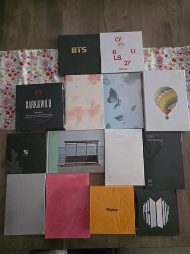 Customer's 'Young Forever' album shown with other BTS albums from their large collection on a table.