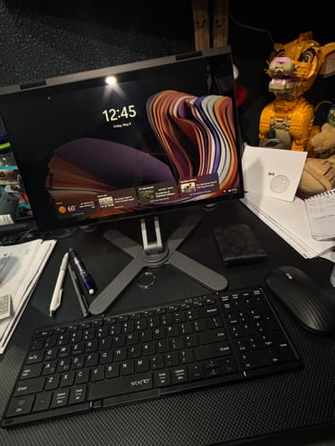 Customer's black CMD-X Keyboard and Mouse on a desk next to a laptop on a stand.