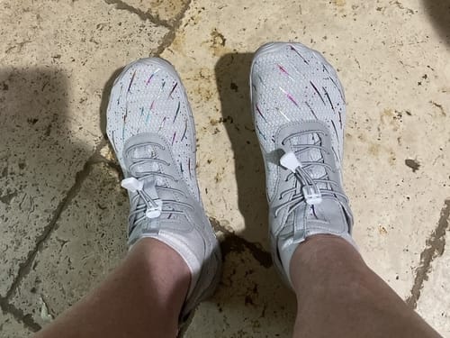 Customer wearing the gray Lorax Pro barefoot shoes with a speckled pattern and toggle laces.