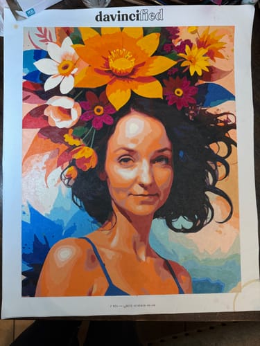 Customer's completed Rainbow Floral Woman paint by numbers kit, showing a colorful portrait of a woman with a floral crown.