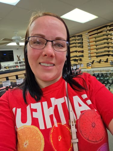 Reviewer with glasses smiling to show her new bright smile with Pop On Veneers.