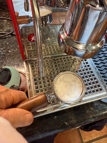 Customer shows an Espresso Paper Filter fitting perfectly inside a 49mm portafilter basket for an Olympia Cremina machine.