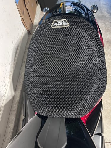 Reviewer's black mesh Wind Rider Seat Cover fitted on a motorcycle seat.