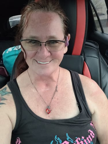 Customer smiling in a car, wearing their white Spare Veneers.