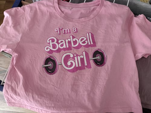 Customer's pink 'I'm a Barbell Girl' loose crop top lying flat.