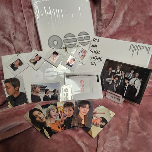 Customer's complete BTS ARIRANG 5TH ALBUM SET laid out, showing albums, photocards, keyrings, and a group photo stand.