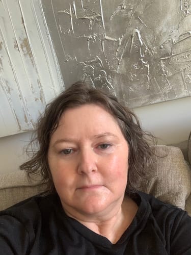 Customer selfie showing her facial skin in a review for The Tallowed Truth Bar.