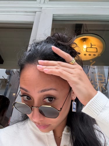 Close-up selfie of the reviewer outdoors, wearing sunglasses; the Sculpt Tank is not visible.