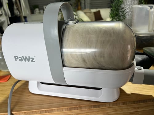 Customer's GroomMate Pet Grooming Kit vacuum unit with its clear canister full of white pet fur.