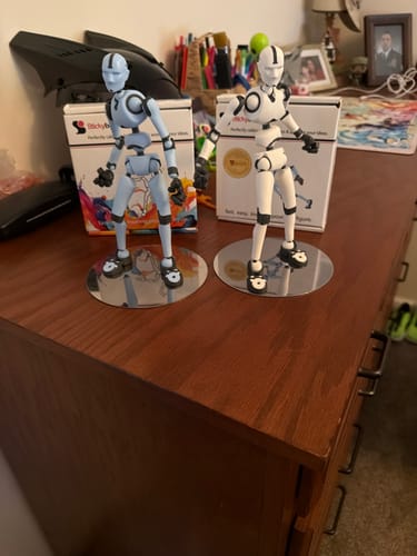Customer's Two Amigos Bundle with light blue and white Stickybones figures posed on a wooden dresser.