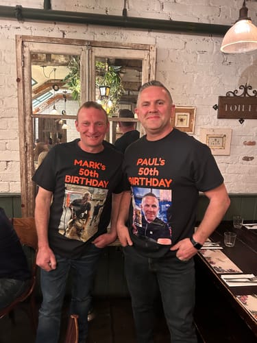 Two customers wearing matching black unisex t-shirts with custom '50th Birthday' text and photos.