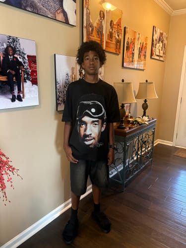 Reviewer standing indoors wearing black Remastered DracoSlides with socks and shorts.
